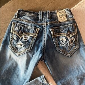 Rock Revival Faded Blue Jeans with Distressed Pockets